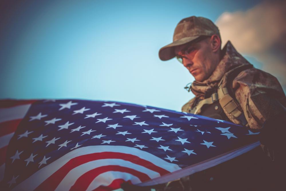 army military veteran holding us flag